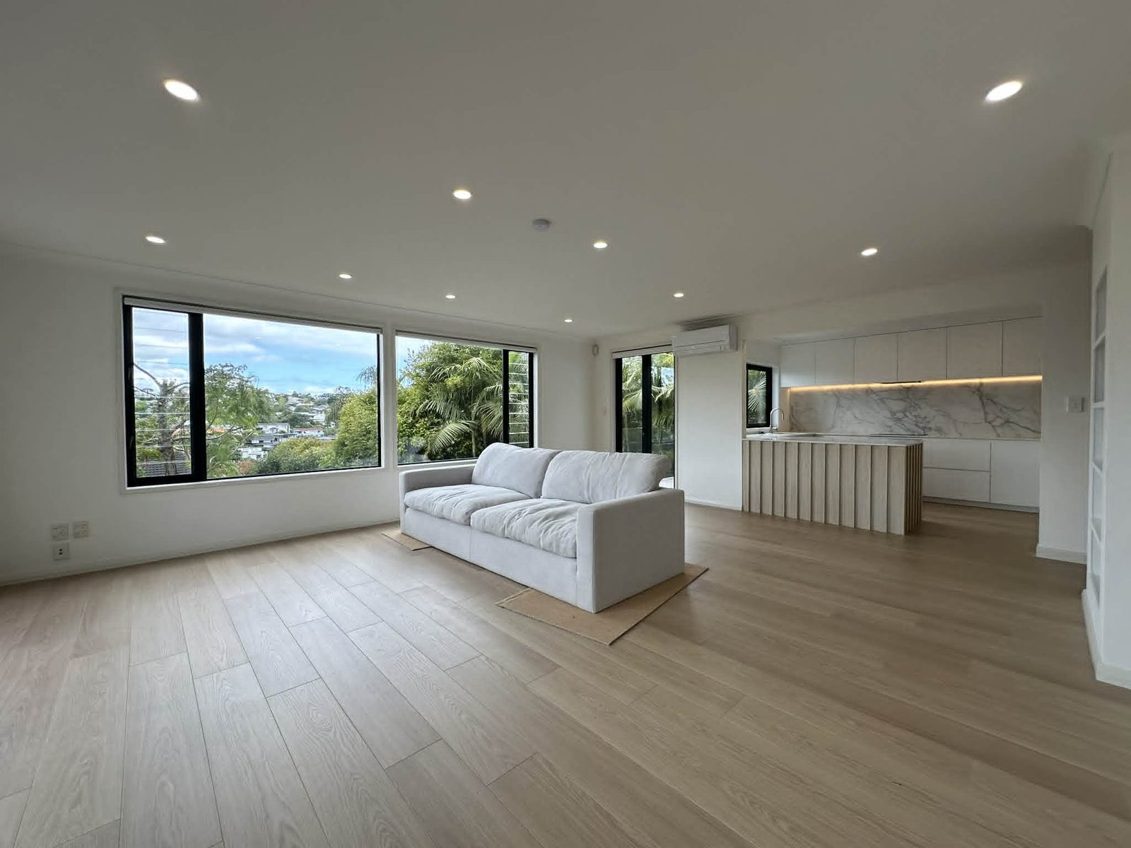 Remuera full renovation — open-plan living with kitchen beyond